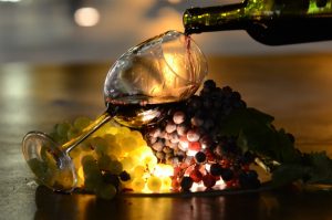 red and white grapes plus red wine being poured