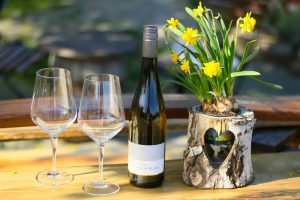 wine and flowers on a stump