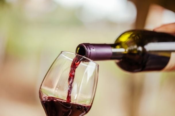 red wine being poured to a glass