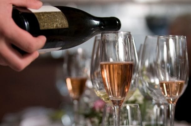 Waiter serving wine