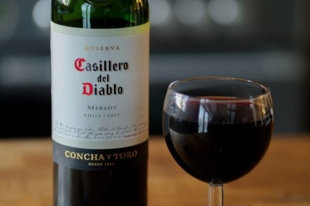 Merlot wine bottle and glass full of wine